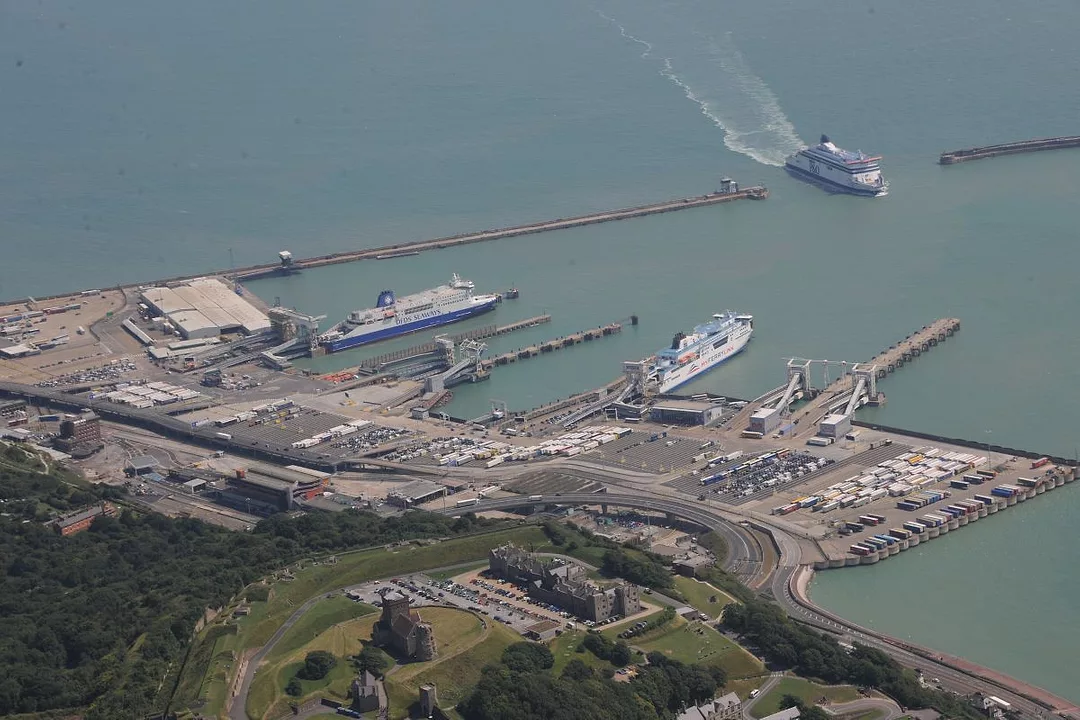 AERIAL SHOT OF PORT WITH SEVERAL FERRIES OR CRUISE SHIPS DOCKED OR APPROACHING