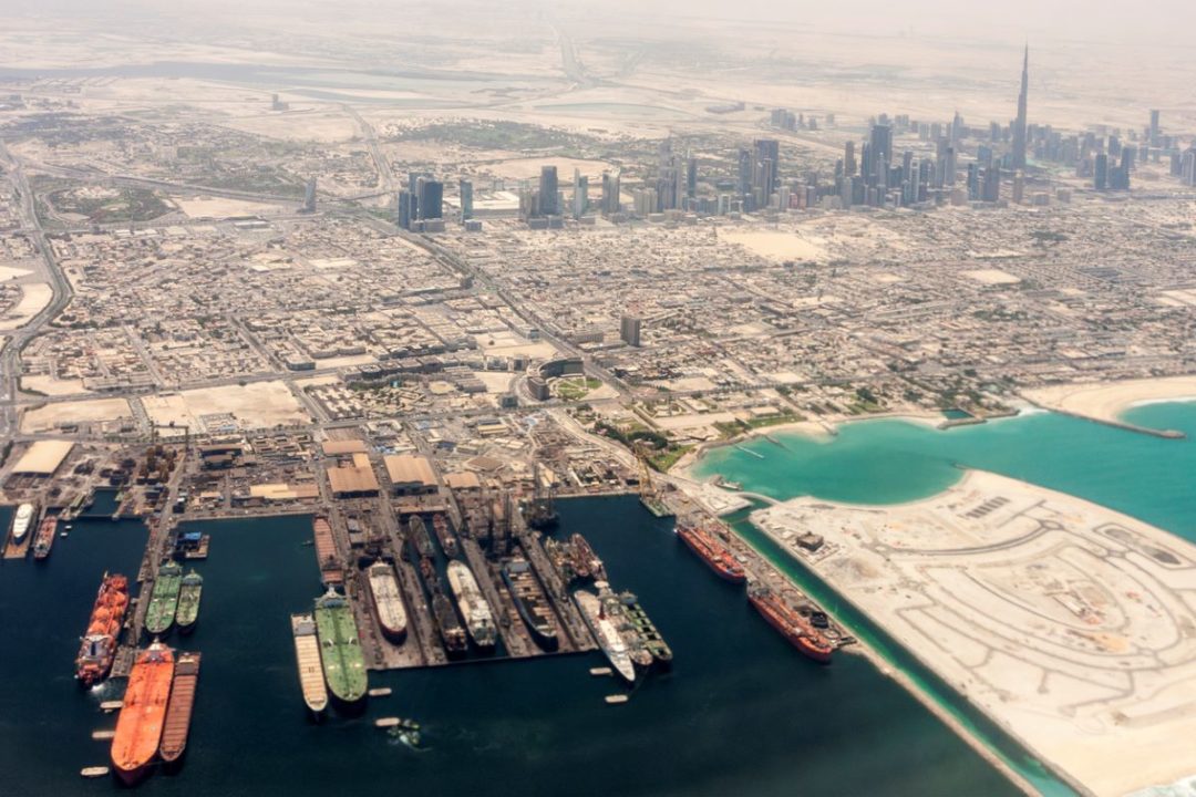 AN AERIAL SHOT OF A MASSIVE PORT COMPLEX ABUTTING A CITY