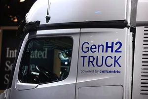 A CLOSE UP SIDE VIEW OF A WHITE TRUCK'S DRIVER DOOR AND SIDE