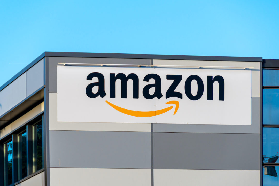May 28, 2022. The exterior of an Amazon Logistics delivery agency located in southern Paris can be seen in front of a blue sky. Photo: iStock.com/HJBC
