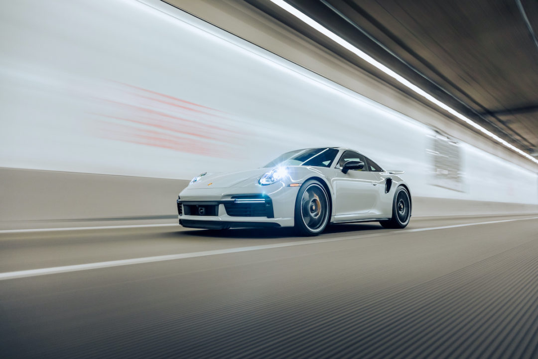 A Porsche 911 Turbo is driving through a tunnel with its lights on in Tacoma, Washington on 5/12/2022. Photo: iStock.com/Brandon Woyshnis