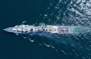 An aerial view of a naval ship, battleship or warship in the middle of the ocean. Photo: iStock.com/alzay