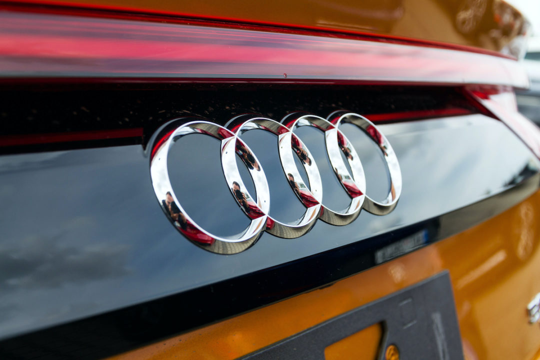 An Audi logo can be seen on a red company car in Prague. Photo: iStock.com/josefkubes