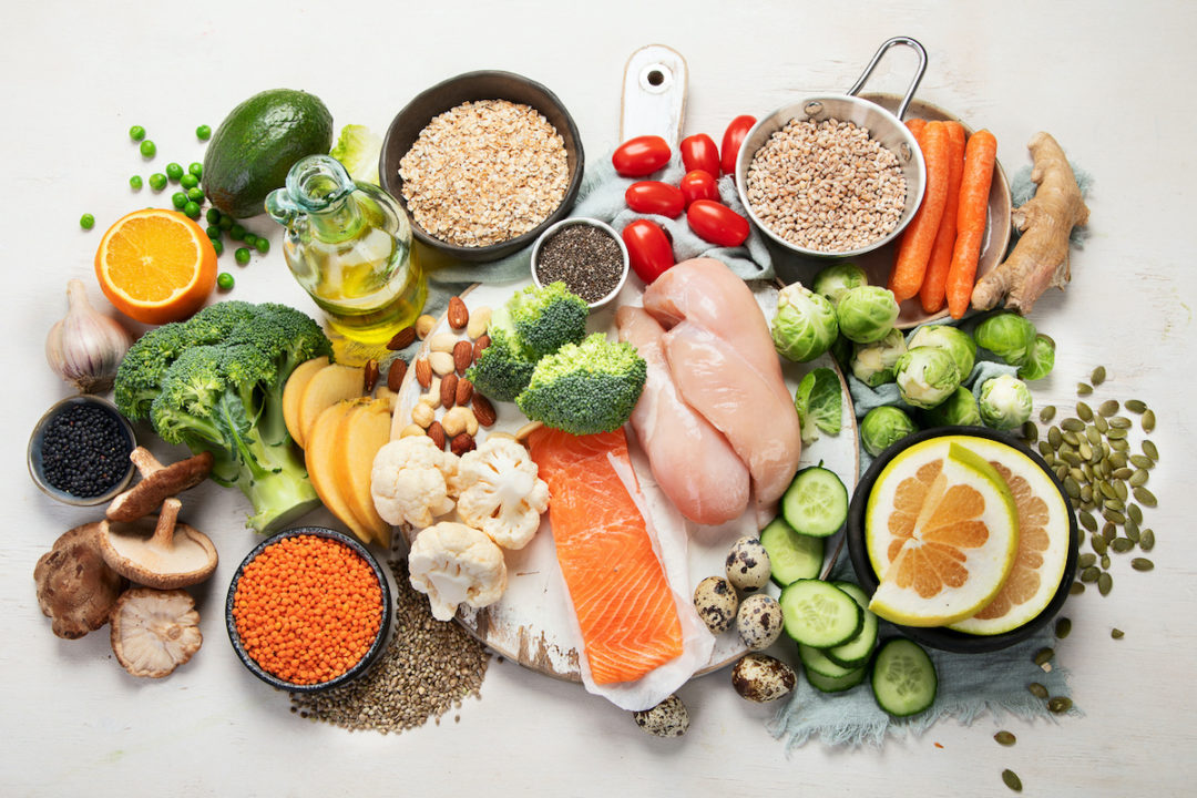 An aerial view of healthy foods can be seen in front of a white background. Photo: iStock.com/bit245