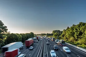 Sunset view of heavy traffic moving at speed on a UK motorway.
