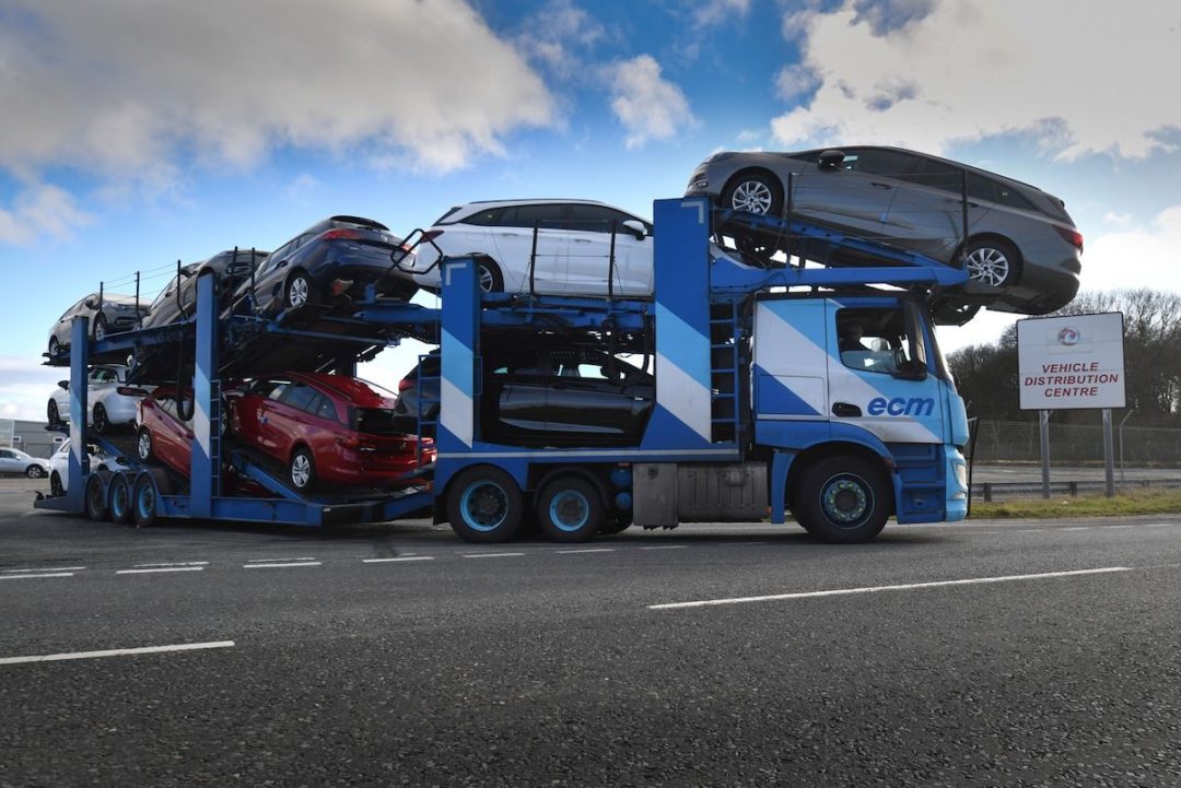 A vehicle transporter leaves the Vauxhall plant in Ellesmere Port, U.K. Photo: Anthony Devlin/Bloomberg