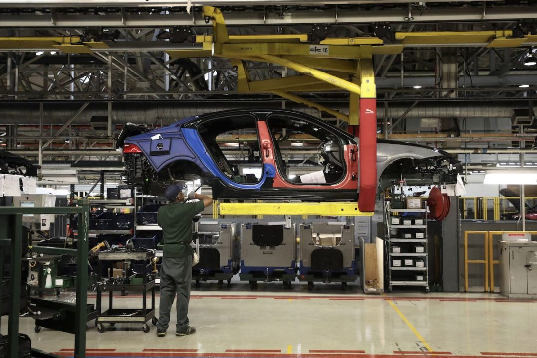 An employee works on a Jaguar XJ automobile on the production line at Tata Motors Ltd.'s Jaguar assembly plant. Photo: Bloomberg