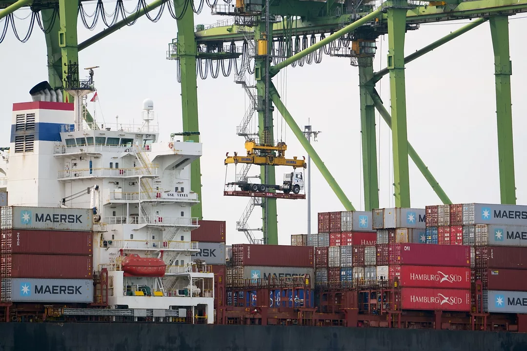 A truck was transported by a gantry crane at Tanjung Priok Port in Jakarta, Indonesia. Photo: Dimas Ardian/Bloomberg