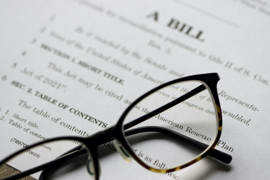 A closeup can be seen of documents for the American Rescue Plan Act of 2021. Photo: iStock.com/hapabapa