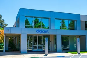 THE EXTERIOR OF A DIGICERT OFFICE BUILDING IN FRONT OF A BLUE SKY.