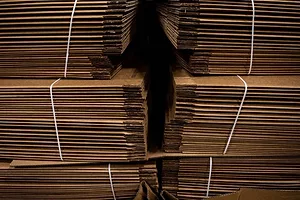 STACKS OF BROWN BOXES ARE BUNDLED TOGETHER
