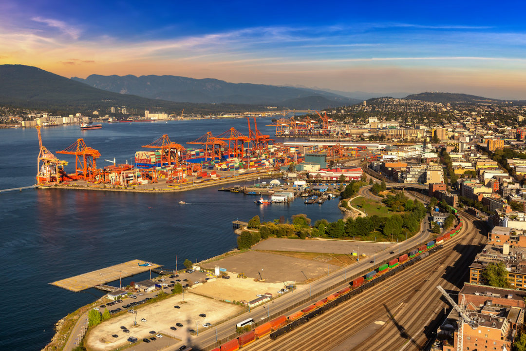 A PANORAMIC AERIAL VIEW OF THE PORT OF CANADA CAN BE SEEN AT SUNSET.