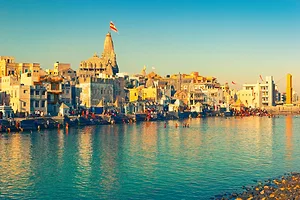 THE LANDSCAPE OF DWARKA, GUJARAT, INDIA CAN BE SEEN ON THE WATER DURING DAYTIME. 