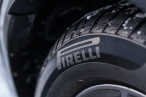 A CLOSE-UP OF A BLACK TIRE ON A CAR SHOWS THE PIRELLI LOGO.