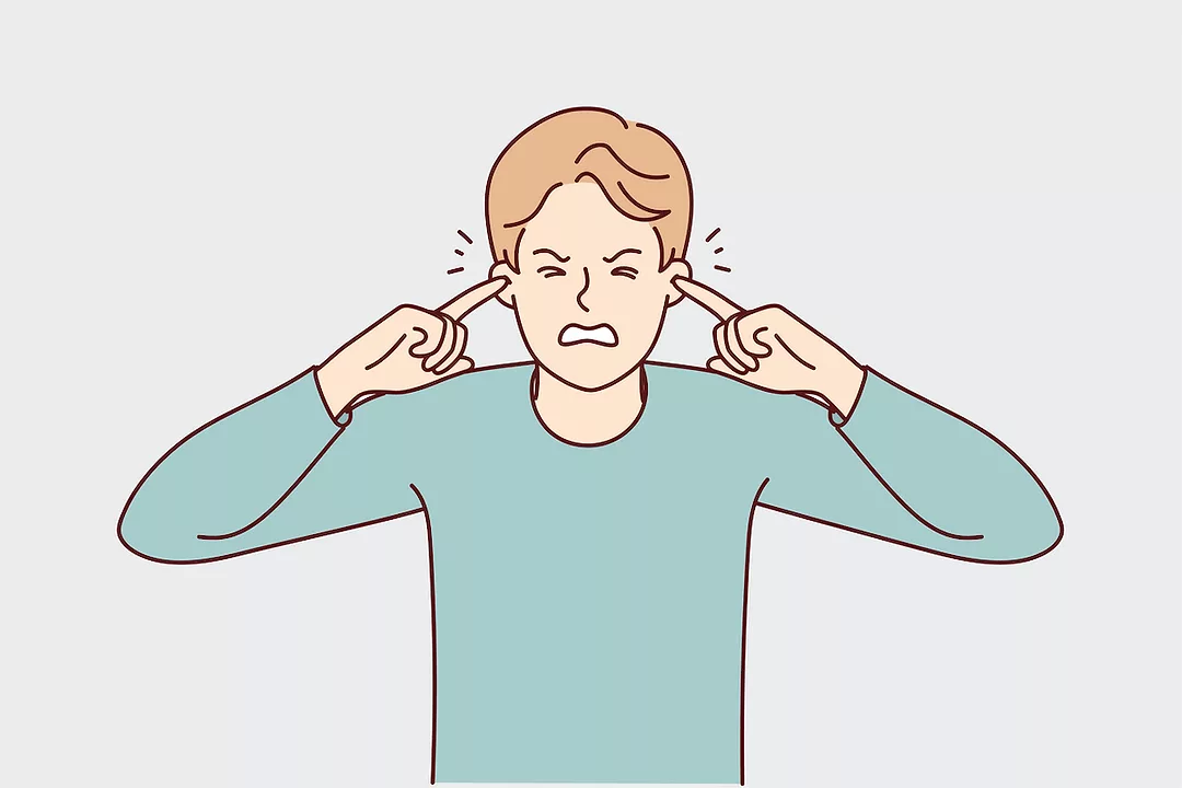 AN ILLUSTRATION DEPICTS AN UNHAPPY MAN WITH HIS EYES CLOSED PLUGGING HIS EARS WITH HIS INDEX FINGERS.