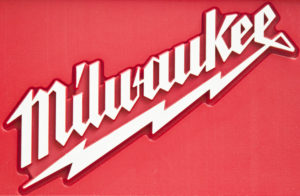 A CLOSE-UP OF THE RED AND WHITE MILWAUKEE TOOL LOGO.