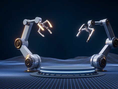 TWO ROBOTIC ARMS BEND TOWARD EACH OTHER OVER A ROUND, ILLUMINATED PLATFORM