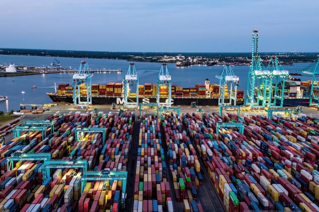 AN AERIAL SHOT OF A LARGE CONTAINER PORT BY TWILIGHT