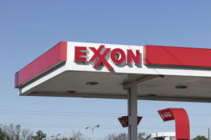 THE EXXON LOGO CAN BE SEEN ATOP A RETAIL GAS STATION.