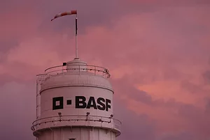 BASF IS WRITTEN ON THE SIDE OF A TOWER AT A CHEMICAL PLANT.