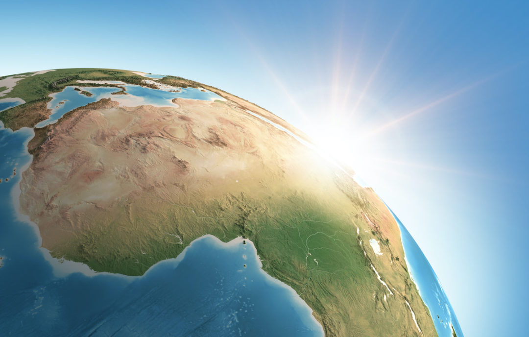 THE SUN IS SHINING OVER A DETAILED VIEW OF PLANET EARTH WITH A FOCUS ON AFRICA.