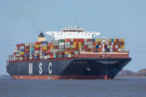 AN MSC CONTAINER VESSEL IS SAILING NEAR LAND.