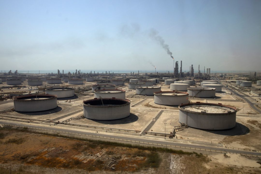 A LARGE GATED FACILITY IS FILLED WITH MULTIPLE CRUDE OIL TANKS.