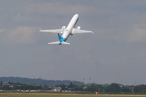 A BOEING 737-10 MAX AIRCRAFT TAKES OFF FROM AN AIRPORT.
