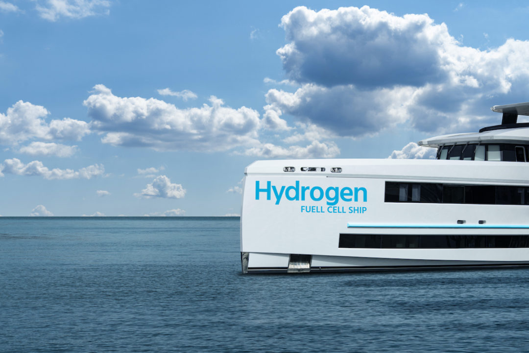 A WHITE YACHT HAS THE WORDS "HYDROGEN FUEL CELL SHIP" WRITTEN ON THE SIDE OF IT IN BLUE.