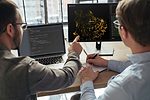DATA SCIENCE MACHINE LEARNING ML ARTIFICIAL INTELLIGENCE AI iStock-Arsenii Palivoda-1455300089.jpg TWO WORKERS DISCUSS DATA SHOWN ON COMPUTER SCREENS