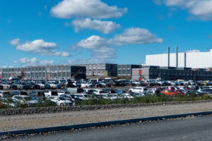 MANY CARS ARE PARKED IN A PARKING LOT OUTSIDE OF A NORTHVOLT FACILITY.