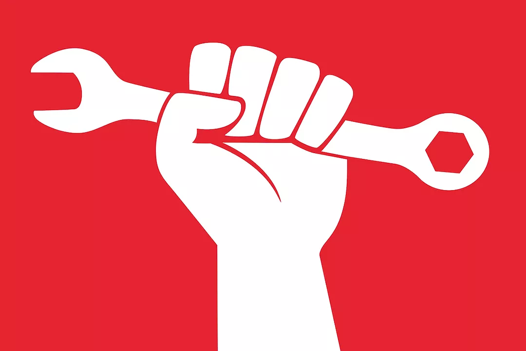 A DRAWING OF A WHITE ARM AND BALLED UP FIST HOLDING A WHITE WRENCH IN FRONT OF A RED BACKGROUND.
