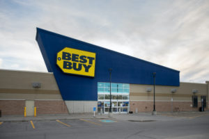 THE EXTERIOR OF A BEST BUY STORE UNDERNEATH A CLOUDY SKY.