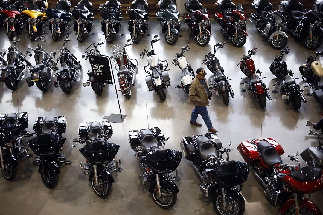 AN ARIAL SHOT OF DOZENS OF MOTORCYCLES IN A SALES ROOM