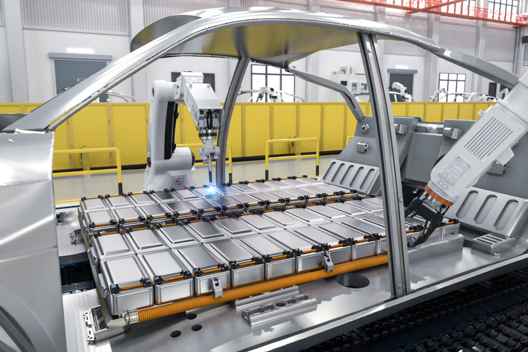 ROBOTIC ARMS ARE ASSEMBLING A CAR ON AN ASSEMBLY LINE.