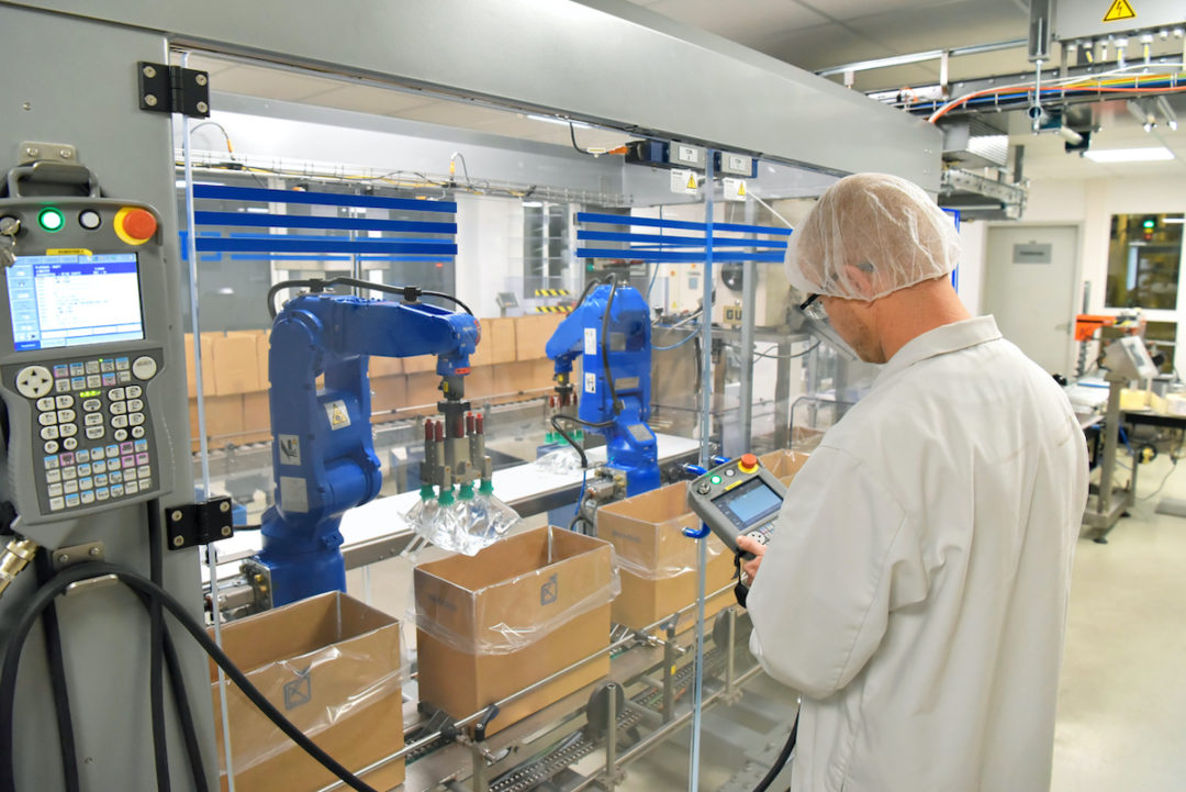 A WORKER OPERATES MACHINERY AT A MEDICAL PRODUCTS MANUFACTURING FACILITY.