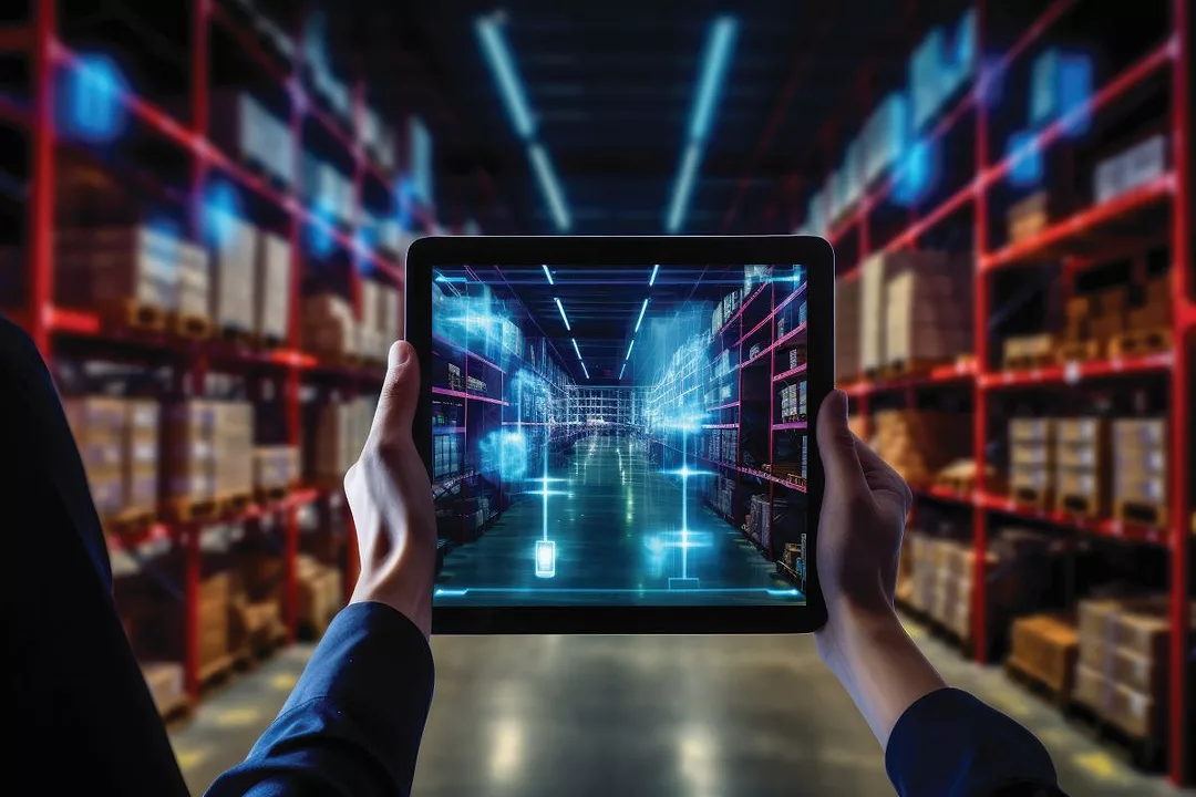 HANDS HOLD A TABLET WITH AN EHANCED IMAGE OF THE WAREHOUSE AISLE BEHIND.