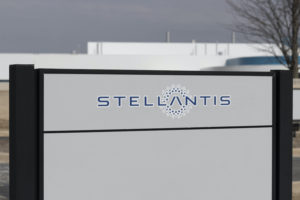A STELLANTIS SIGN SITS IN FRONT OF A FACTORY.