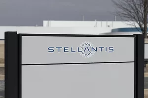A STELLANTIS SIGN SITS IN FRONT OF A FACTORY.