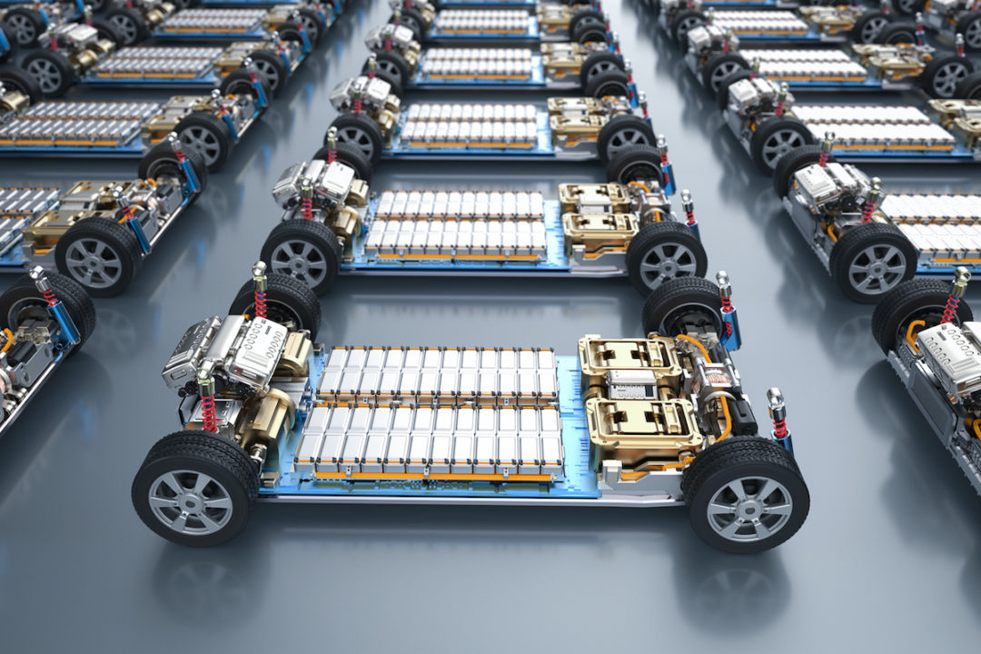 SEVERAL ROWS OF ELECTRIC VEHICLE FRAMES CONTAIN BATTERY CELL MODULES.