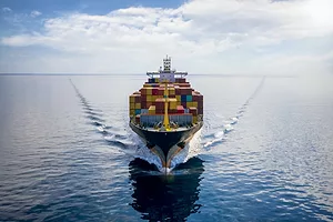 AERIAL FRONT VIEW OF A LOADED CONTAINER VESSEL.