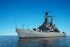 A MODERN WARSHIP PLIES THE OPEN OCEAN.