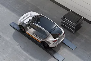  A GRAPHIC SHOWS A CAR PARKED NEXT TO A STACK OF LARGE OBLONG OBJECTS.