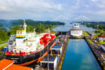 TWO CARGO SHIPS DOCKED AT THE MIRAFLORES LOCKS IN THE PANAMA CANAL.
