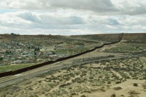 Train Tracks and Road on Either Side of US/Mexico Border Wall Near El Paso