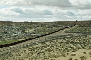 Train Tracks and Road on Either Side of US/Mexico Border Wall Near El Paso