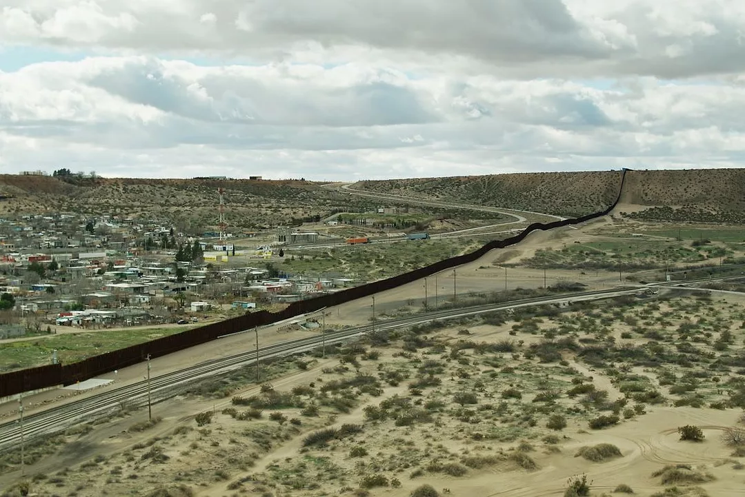 Train Tracks and Road on Either Side of US/Mexico Border Wall Near El Paso
