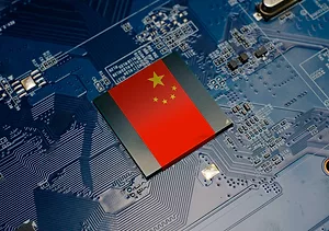 A CHINESE FLAG EMBEDDED ON THE CPU OF AN ELECTRICAL CIRCUIT BOARD.