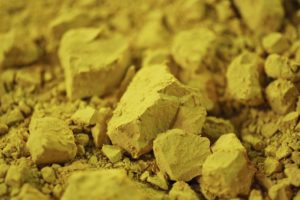 A LARGE PILE OF YELLOW URANIUM CONCENTRATE.