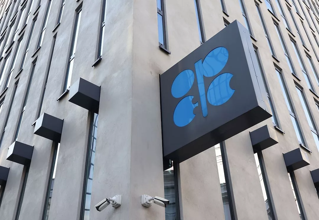 AN OPEC SIGN ON THE CORNER OF A BRICK BUILDING.